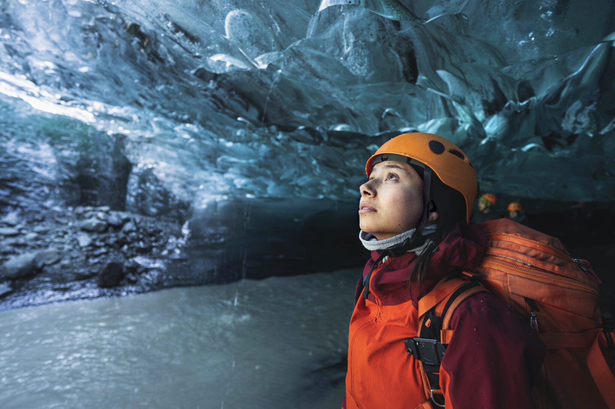 Female explorer in the ice cave, Iceland