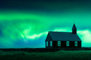 Aurora borealis Northern lights over famous picturesque black church of Budir at Snaefellsnes peninsula region in Iceland. Landscape photography. Courtesy of NASA. Photo collage