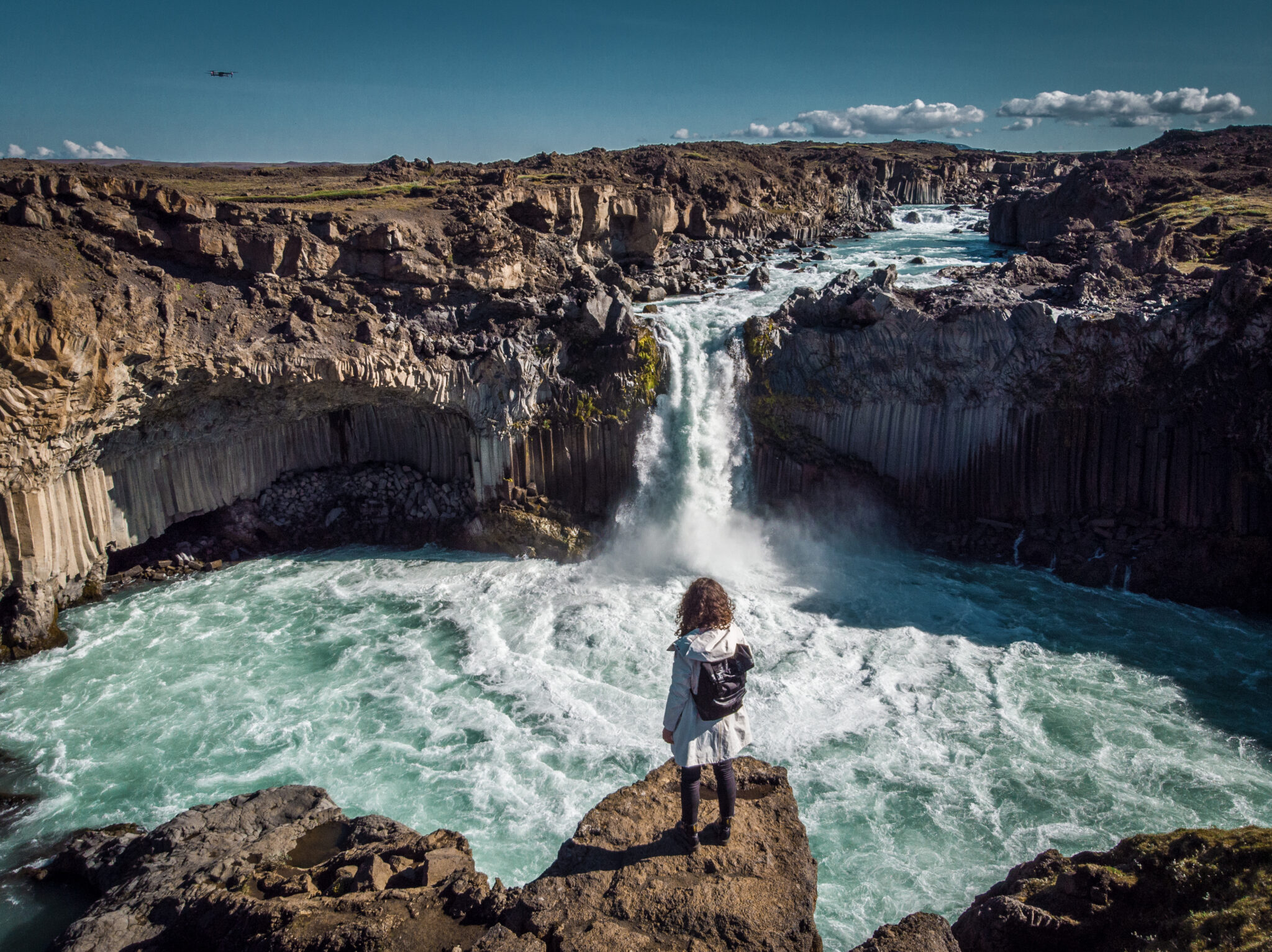 Woman stay on waterfall in Iceland, hide waterfall in Iceland, amazing sights and places to explore